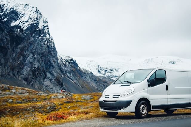 image of a large white van with scenic background