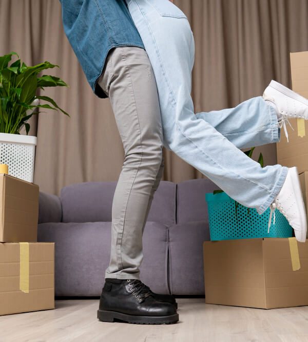 Man lifting and hugging his girlfriend with boxes around them