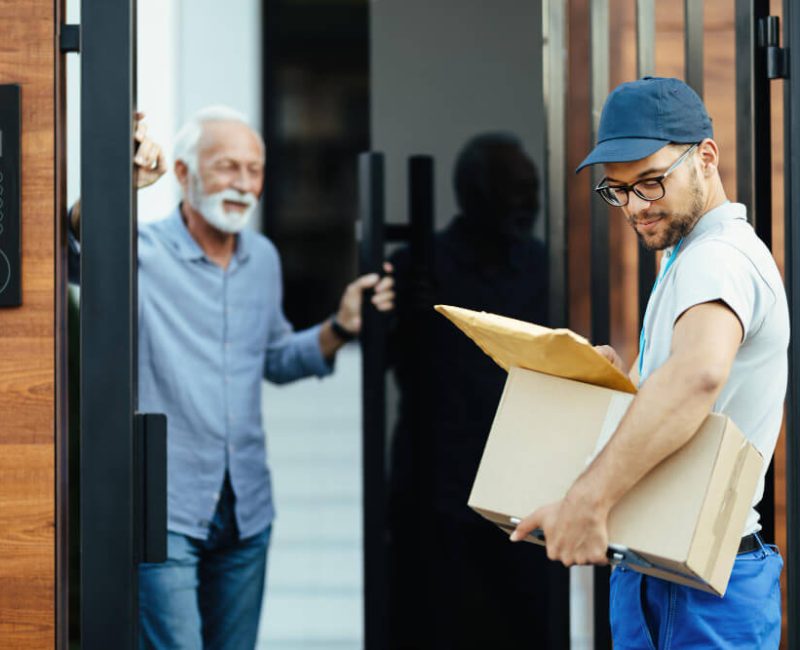 man collecting a Door to Door Service from agent delivery driver