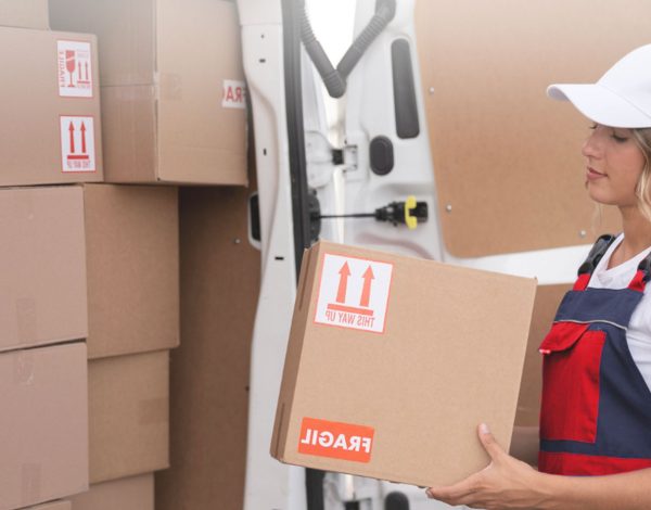 A woman packing boxes for a long distant move from Glasgow to somewhere in UK