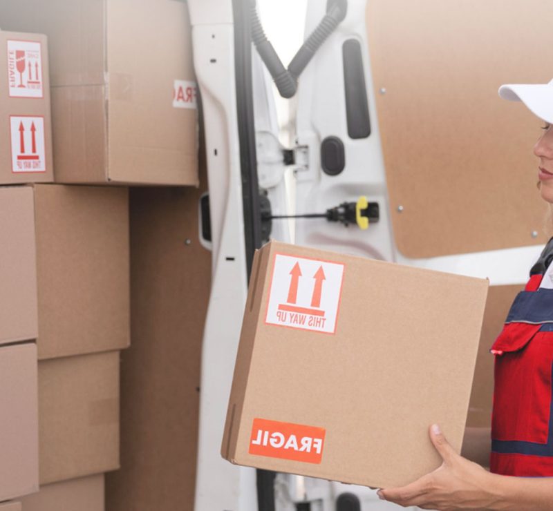 A woman packing boxes for a long distant move from Glasgow to somewhere in UK